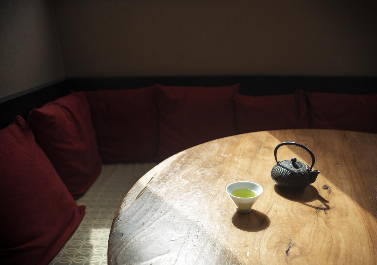 a wooden table with a tea pot on it