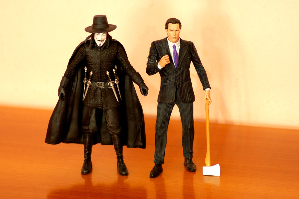 two black and white action figures next to each other on the table