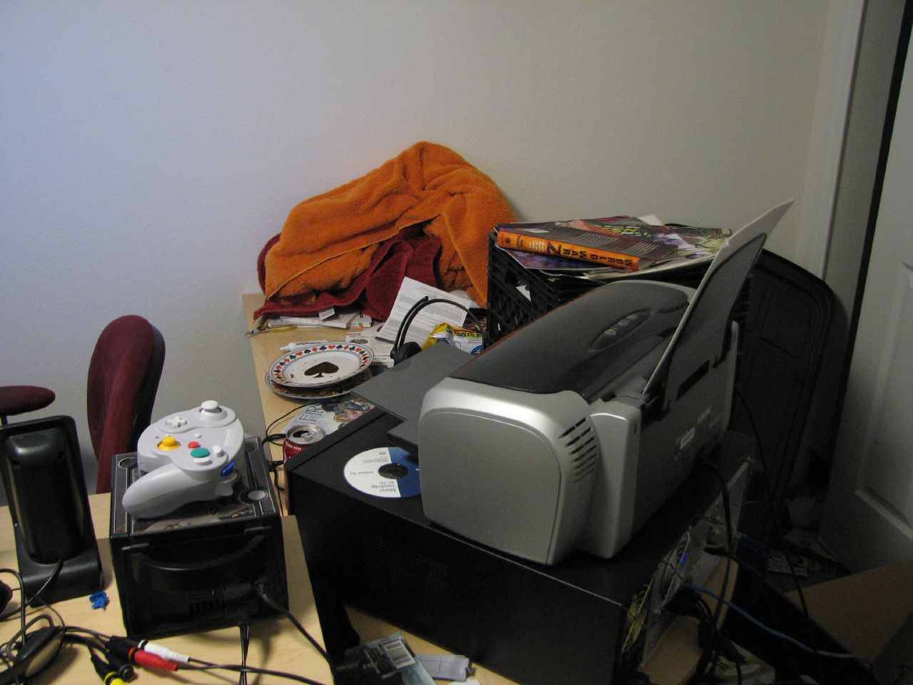 a desk with many electronics and books on it