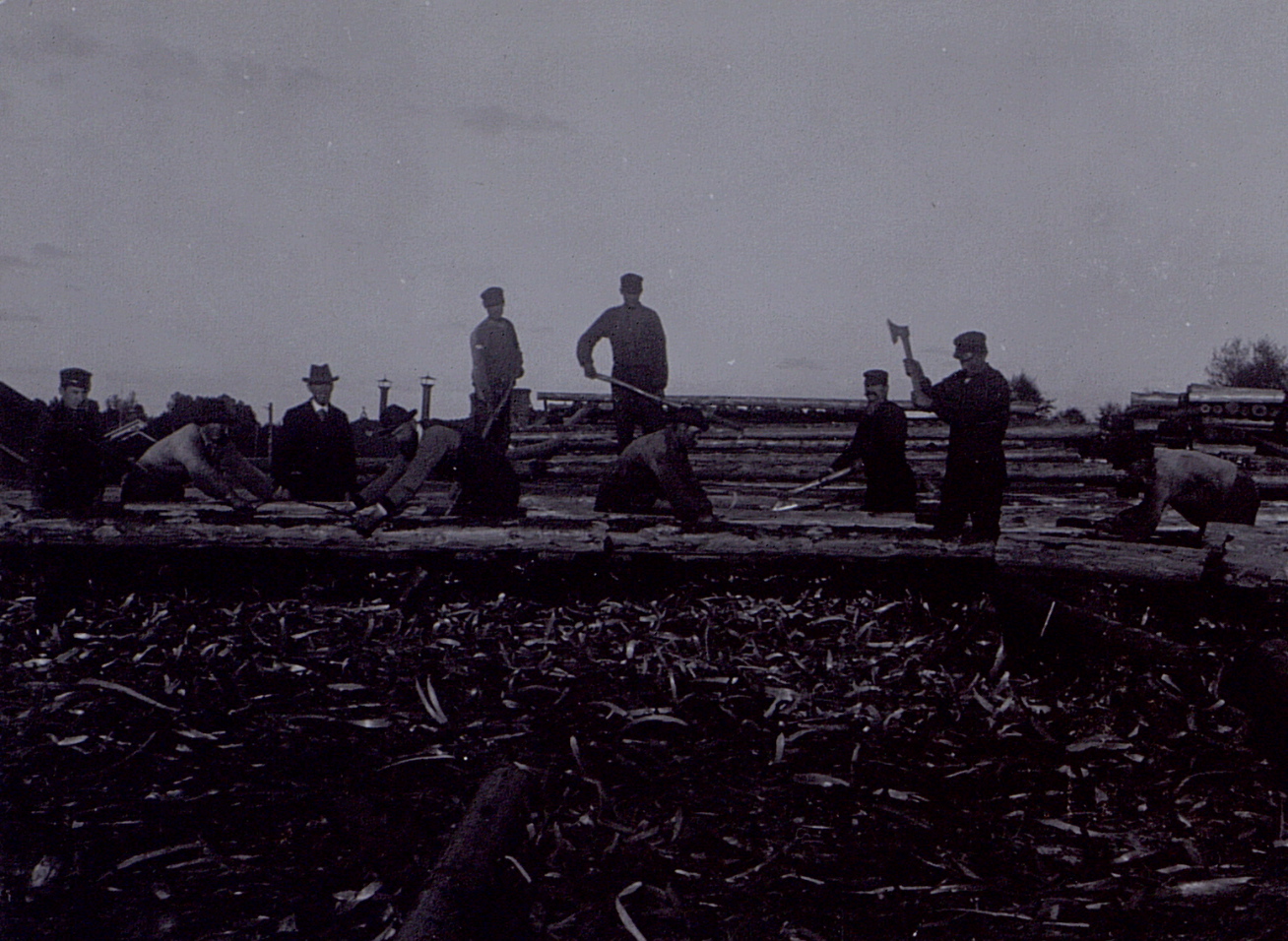 several people standing on the side of railroad tracks