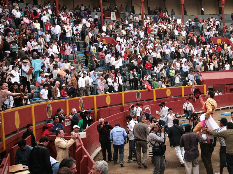 a bunch of people standing around in an arena