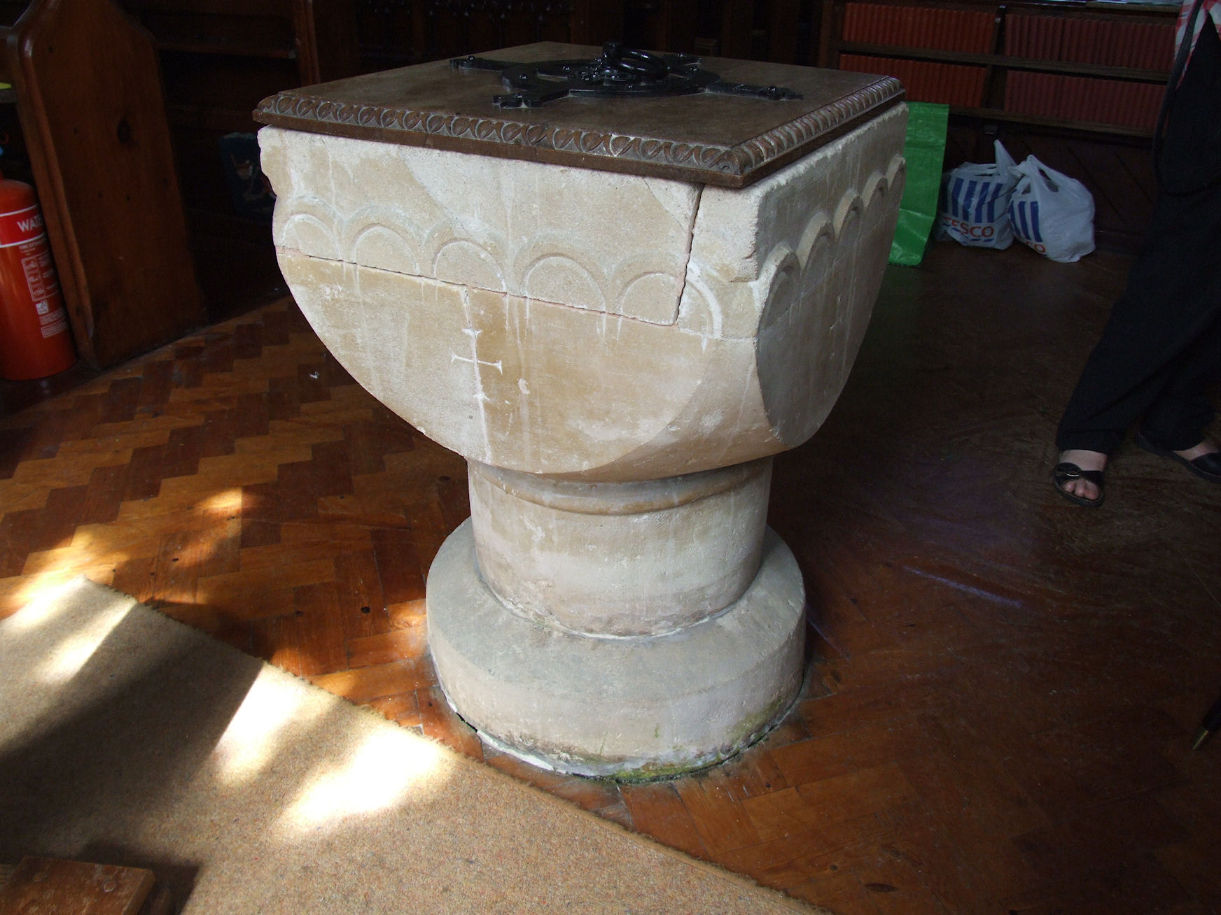 a urinal on top of a wooden floor in a room