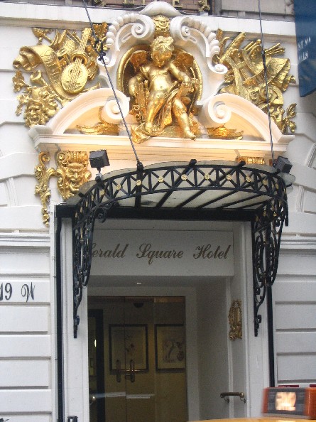 a doorway with a gold sculpture above it that is closed
