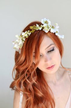 a beautiful woman wearing a white flower crown