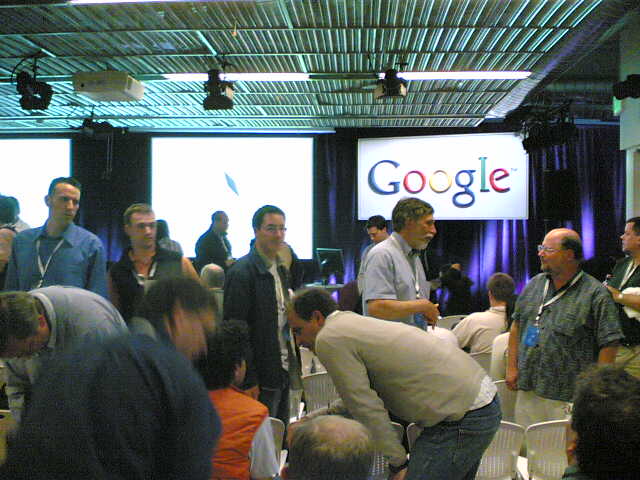 people gathered in front of a large google sign