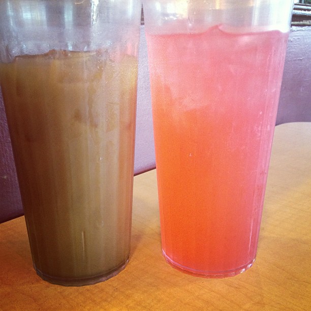 two cups with different drinks sitting on top of each other