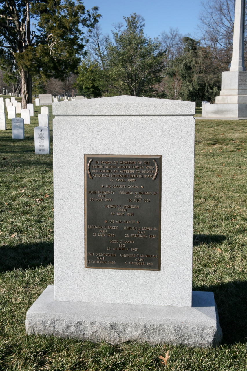 an obelisk in the grass that features an inscription