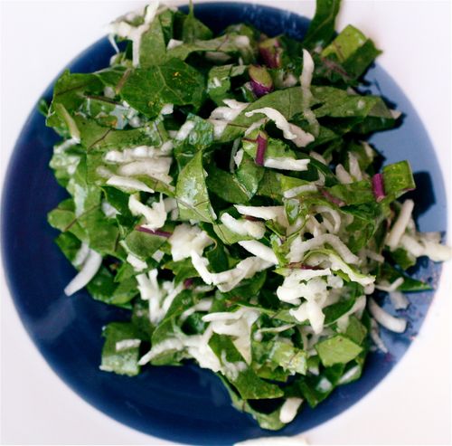 a bowl of lettuce and white slurved dressing