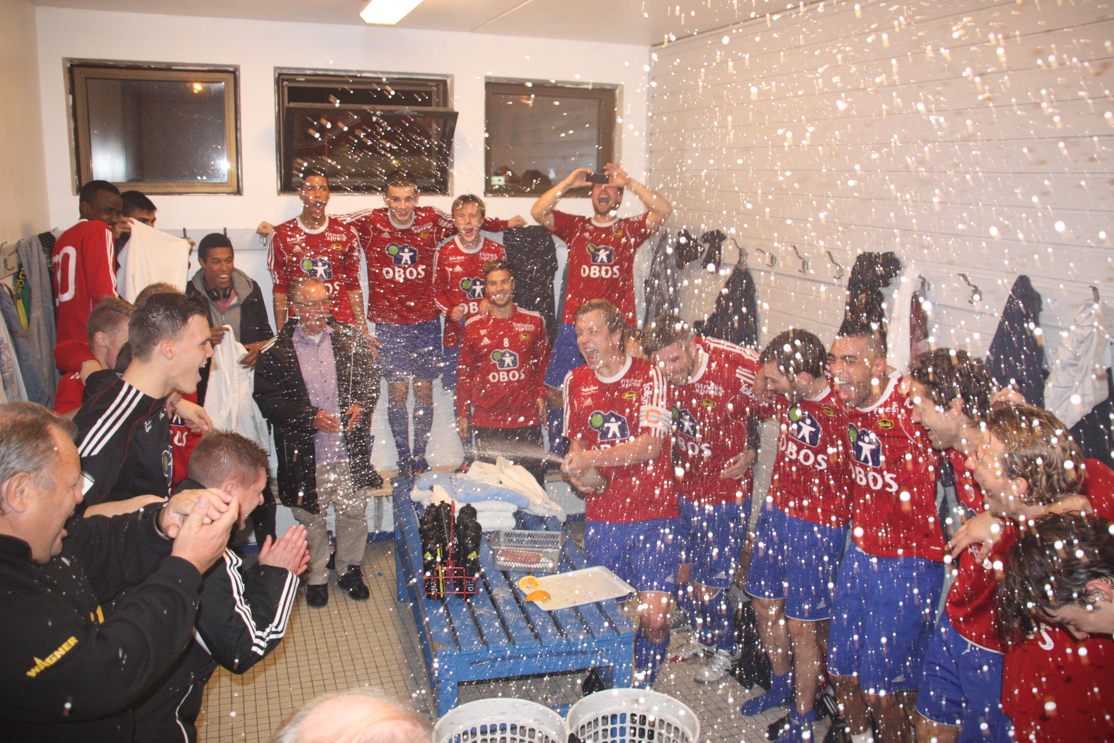 a group of soccer players holding their trophies