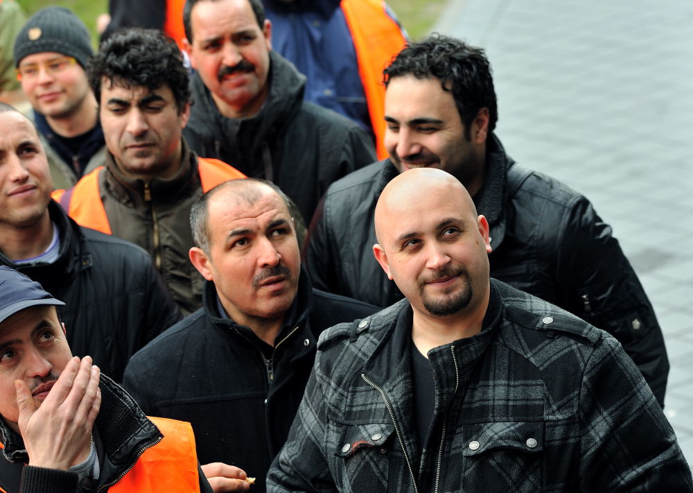 a group of men in orange vests are posing for a picture