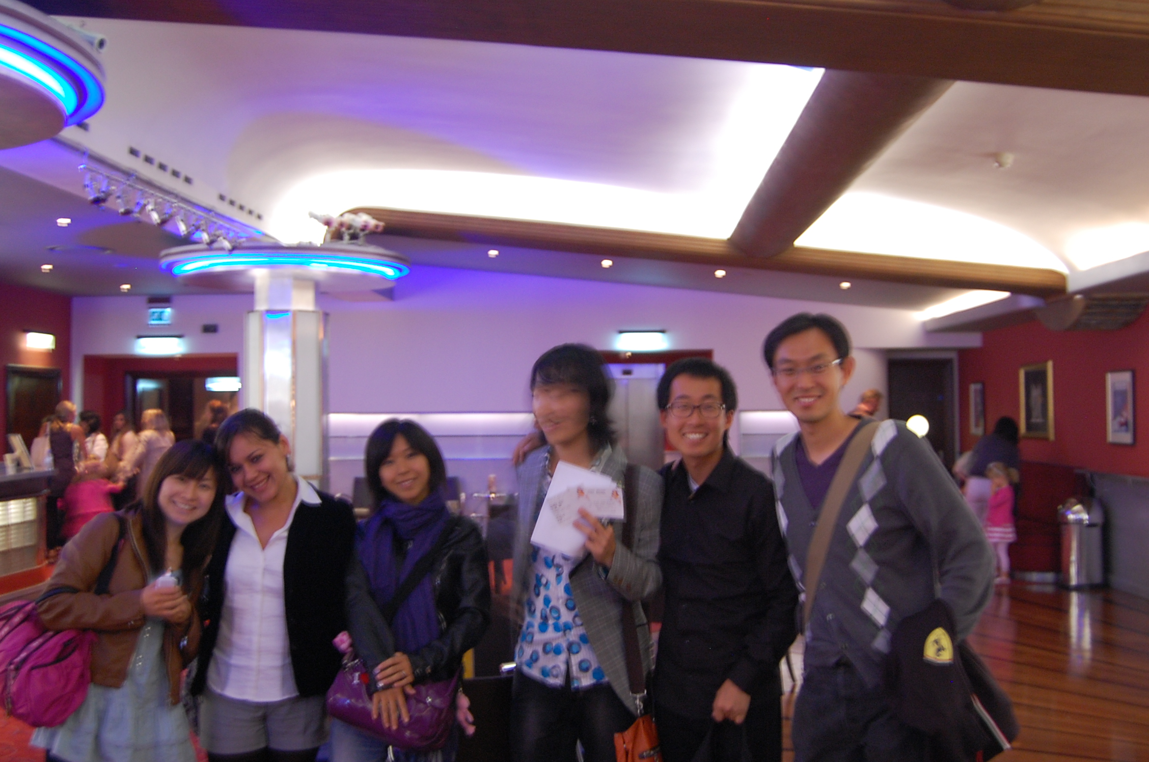 a group of people standing on top of a wooden floor