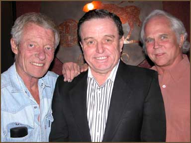 three older men standing close to one another