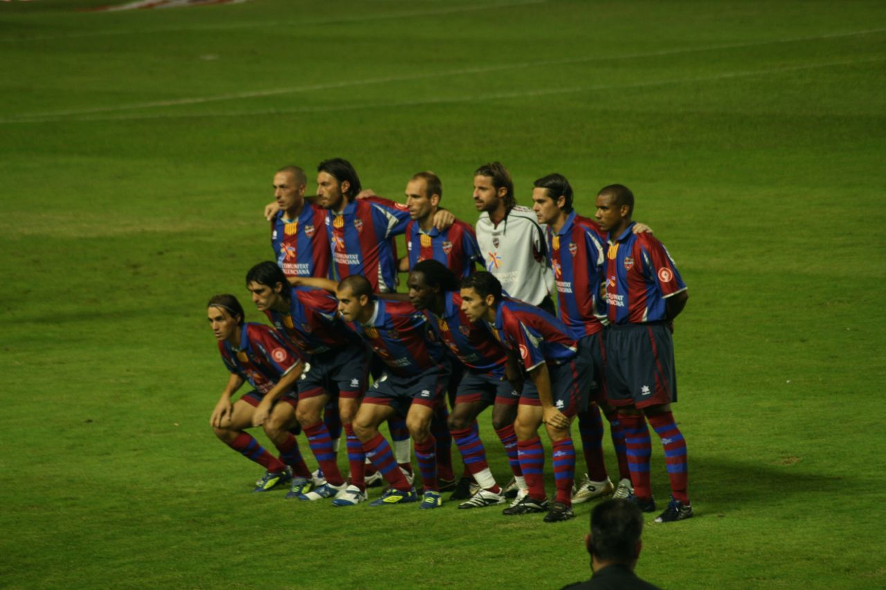 soccer team posing for group po on field