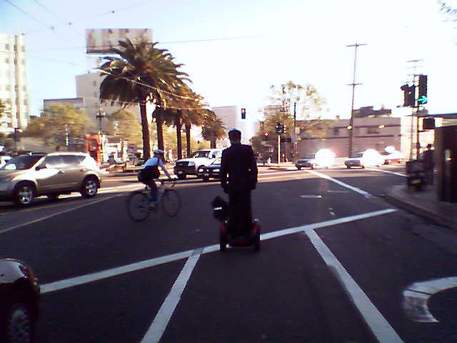 a man crossing the street with a suitcase