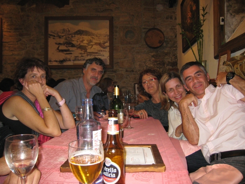 group of people seated at table at restaurant smiling for po