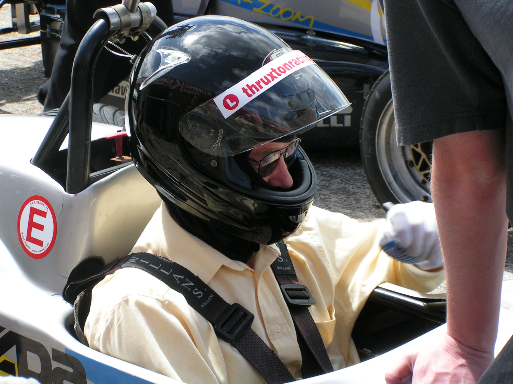 a person in a racing car wearing a helmet
