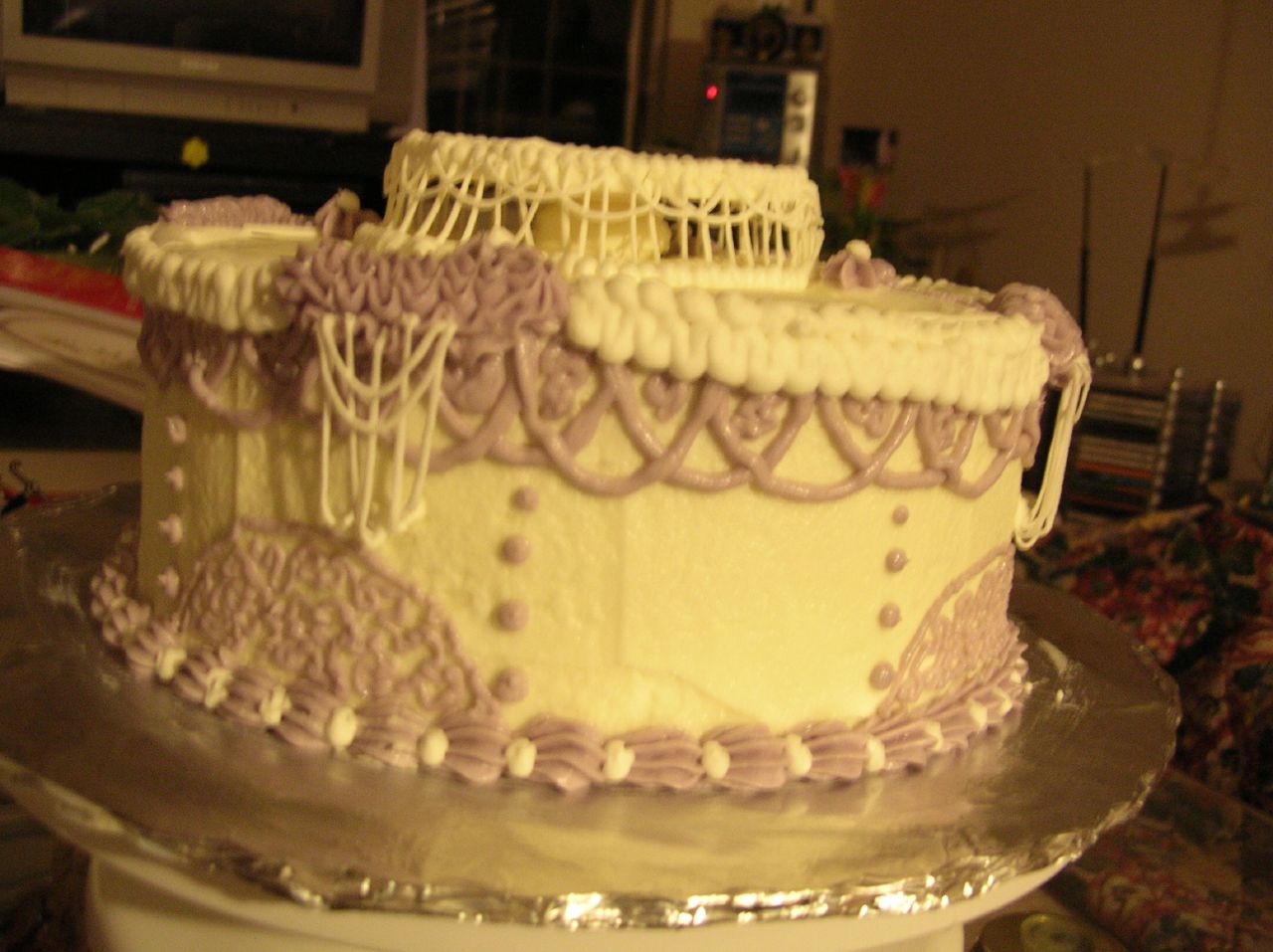 a cake sitting on top of a plate with purple lace