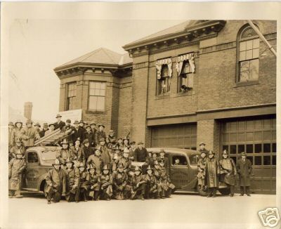 a group of men pose for a po in front of a large building
