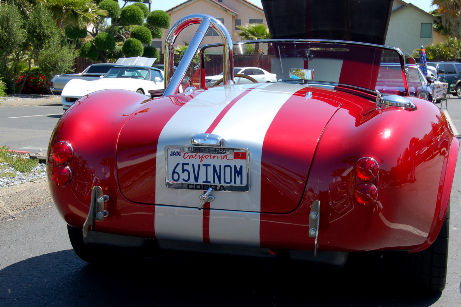 a classic convertible car parked on the side of a road