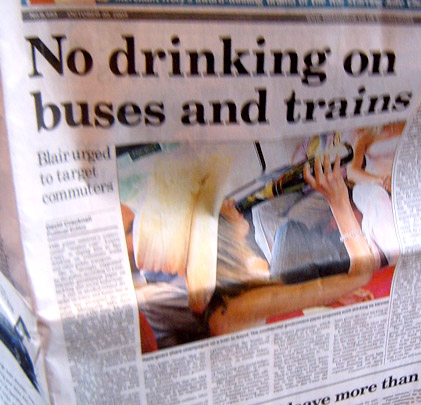 a newspaper with a picture of two people drinking