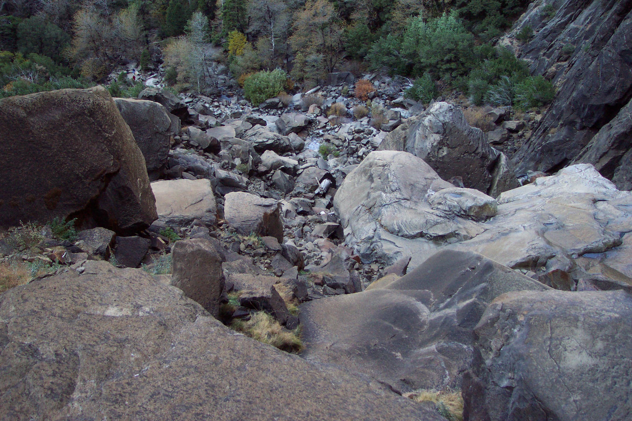 rocky terrain with rocks and boulders next to a cliff