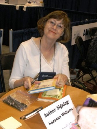 a woman at a table with several books