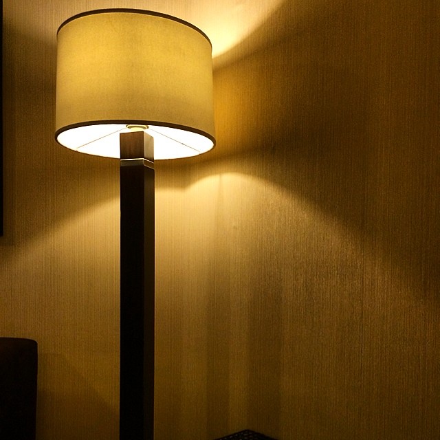 a lamp sits on the corner of a room
