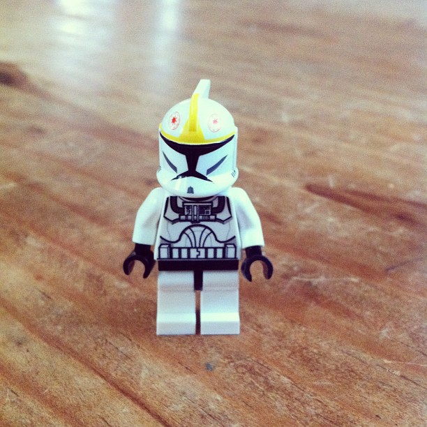 a lego trooper character is on a wooden table