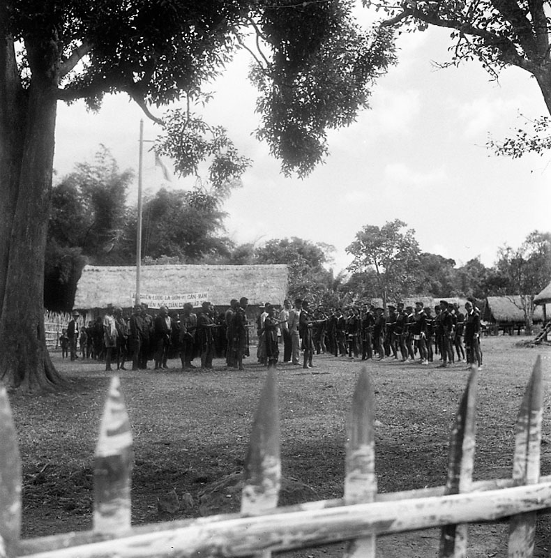 a black and white po of people in a field