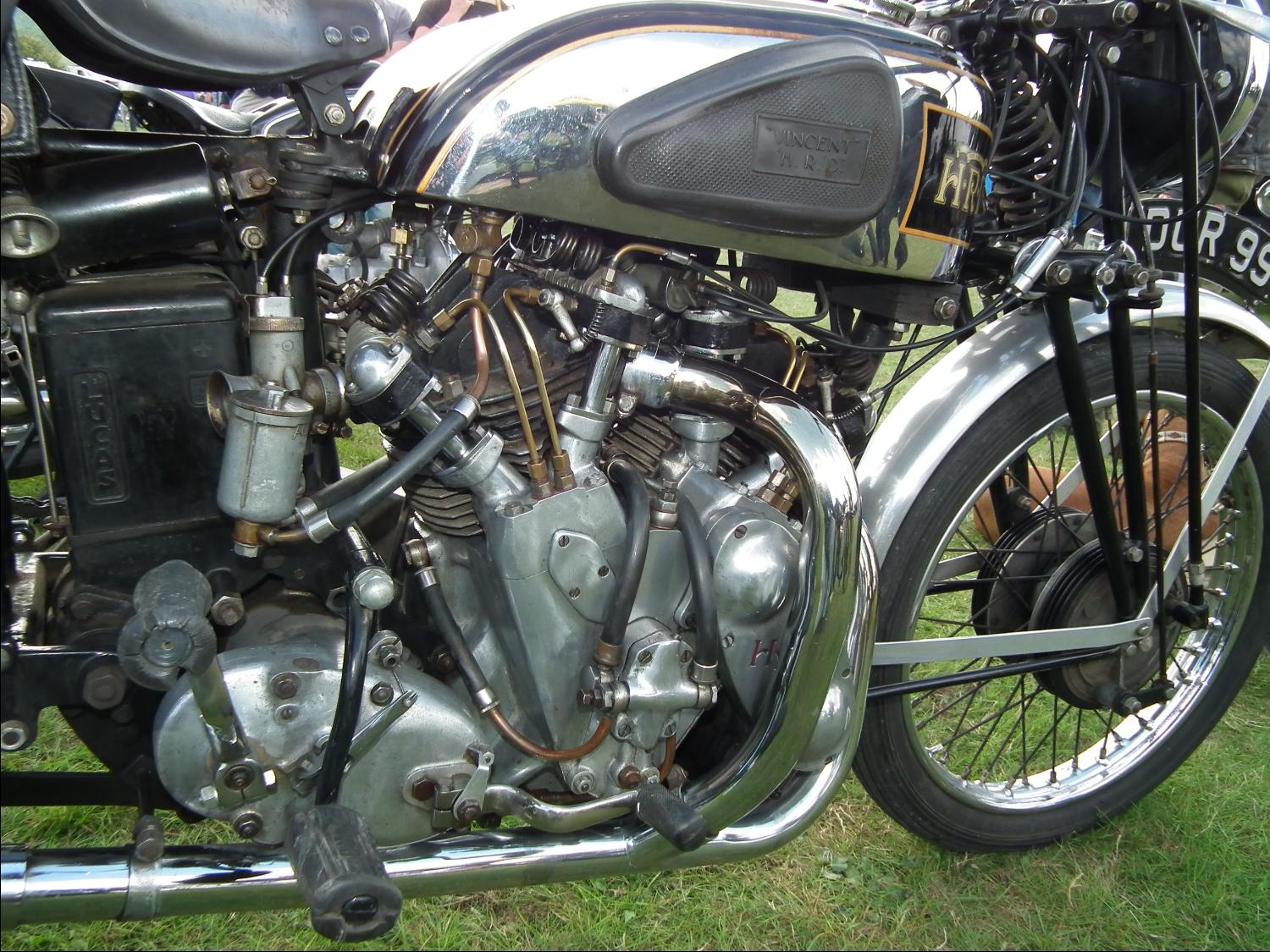 an old fashion motorcycle is displayed on the grass