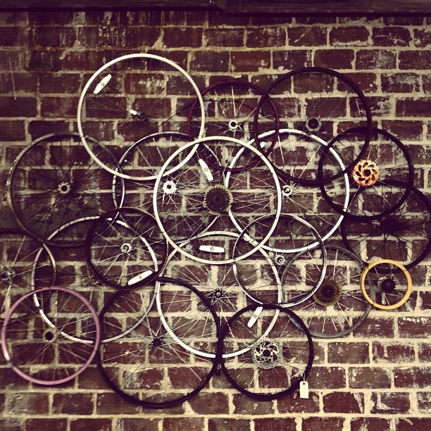 a bicycle bike rack hanging on the side of a brick wall