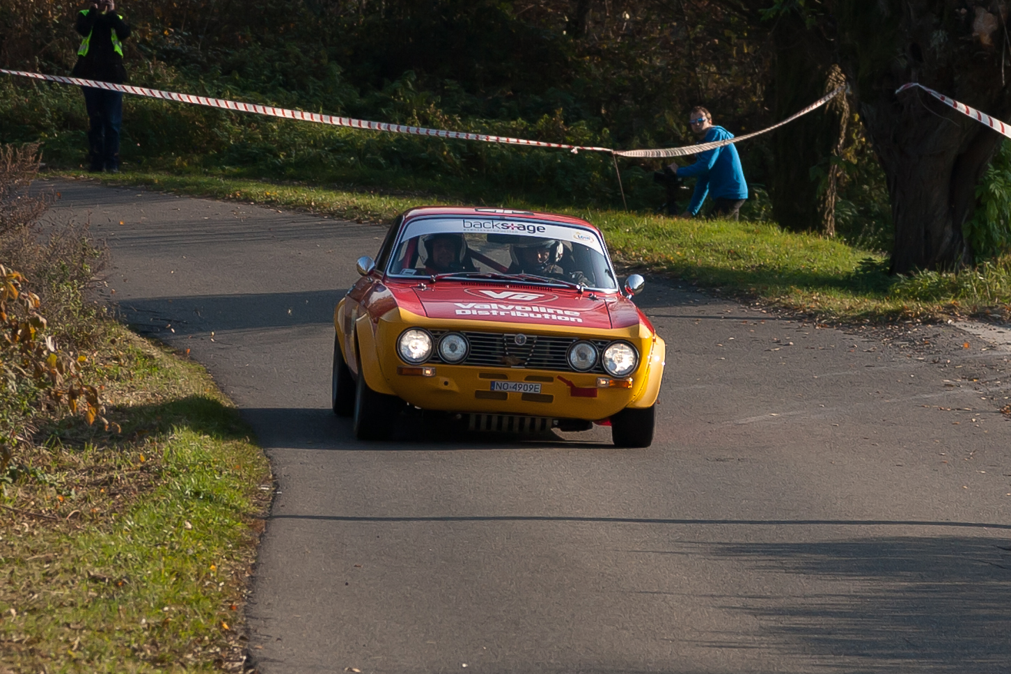 a car that is driving on a road near grass