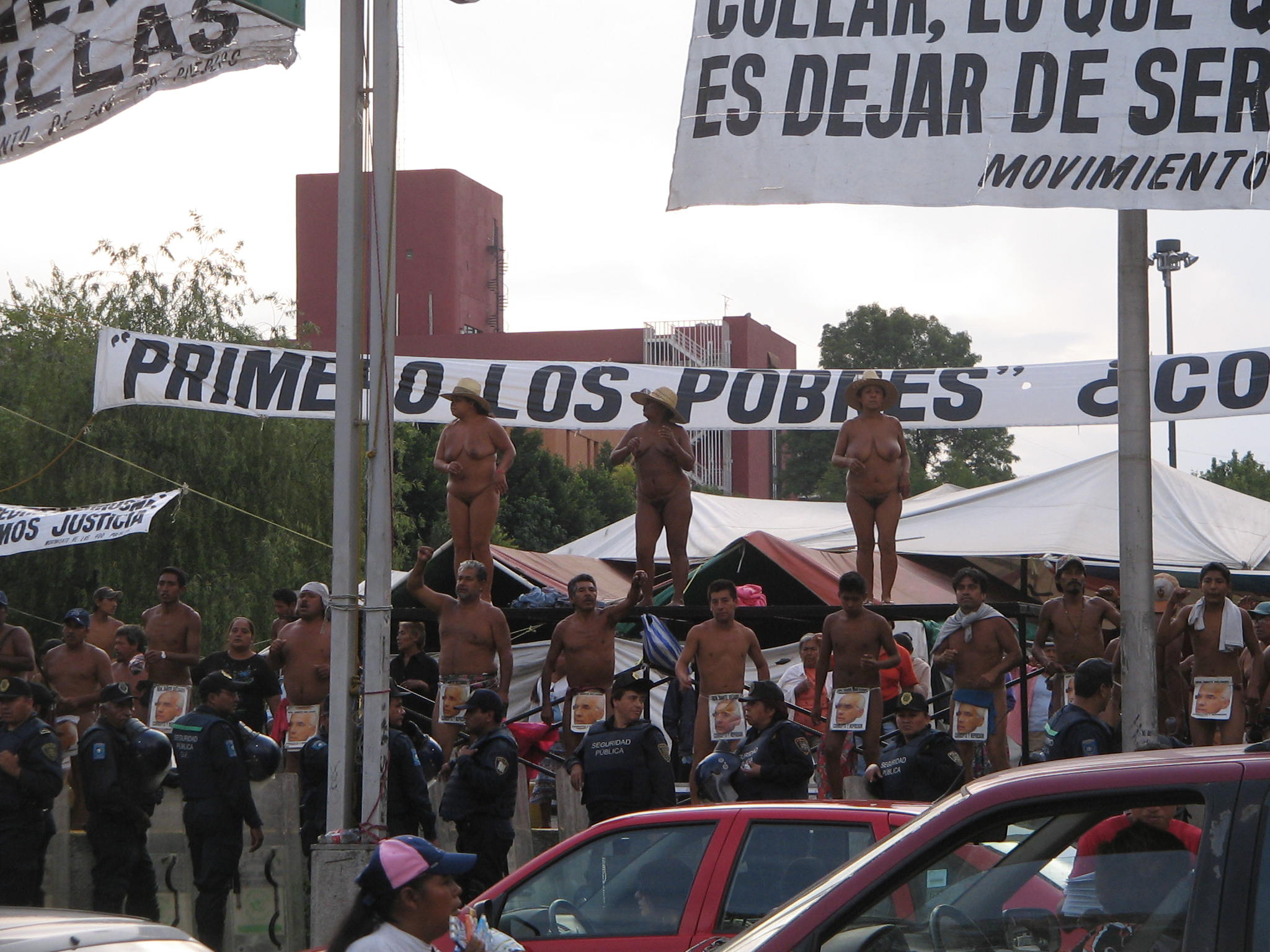  people posing in different positions and holding a large banner