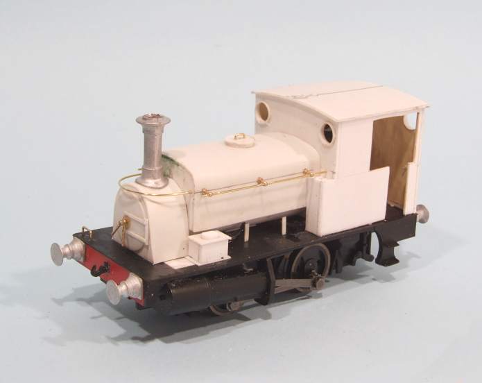 a toy train sits on a white surface