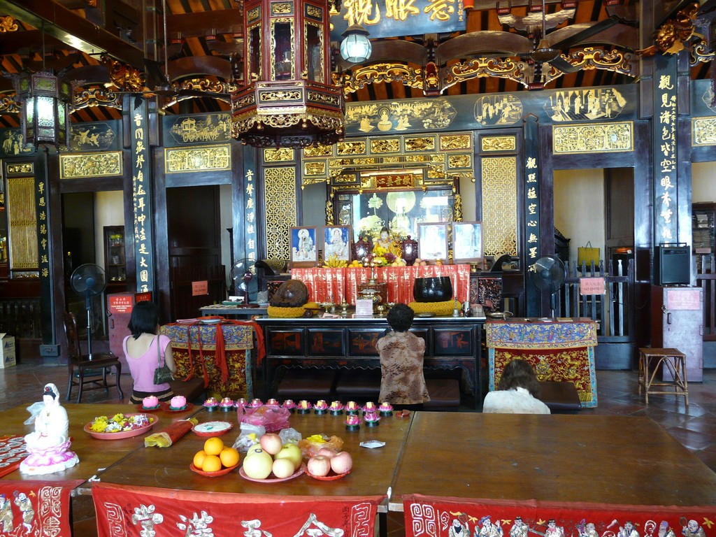 an altar with figurines on it in a large room