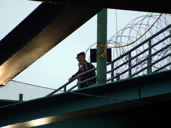 a man is standing on top of a bridge