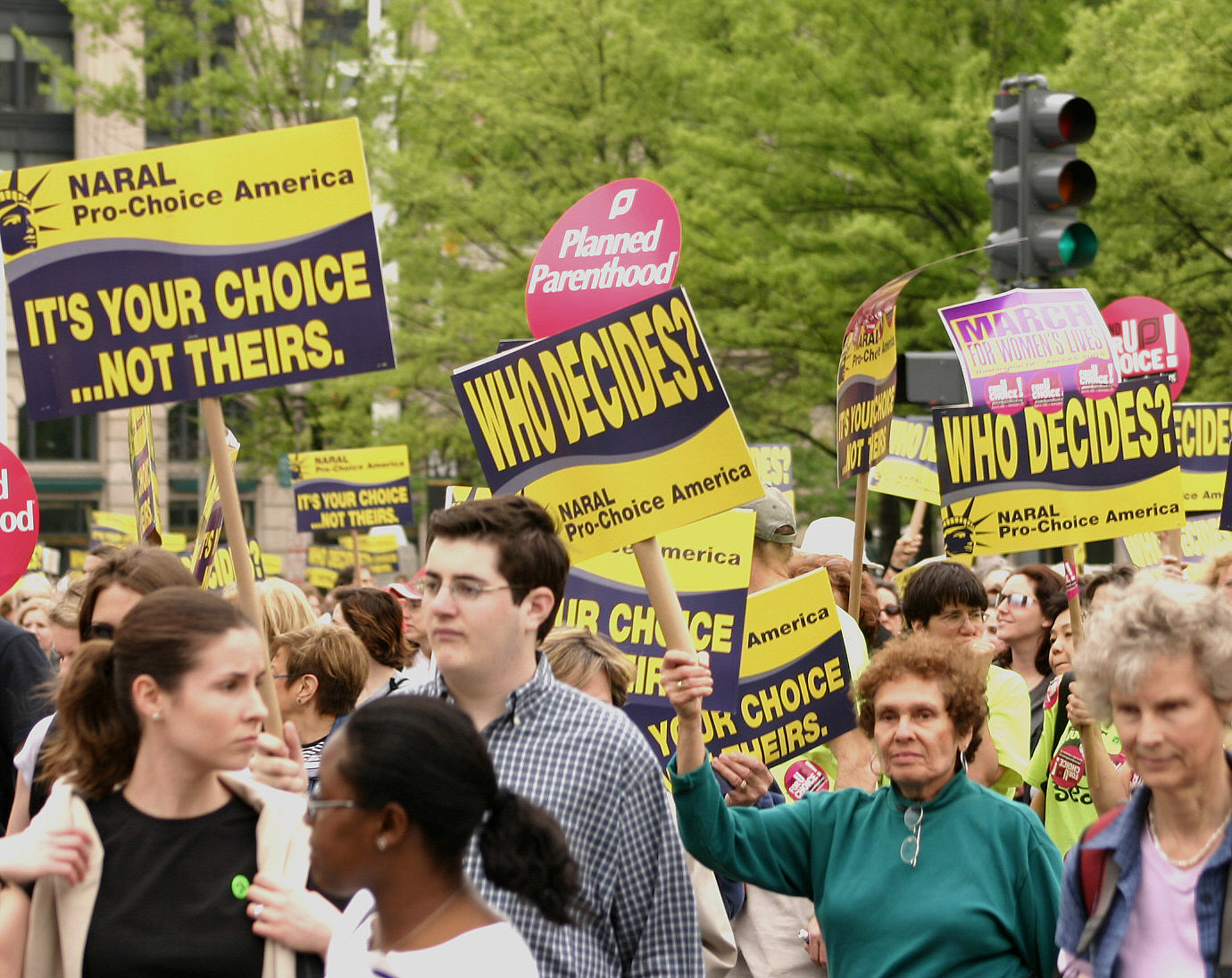 a crowd holding signs and other protesting signs