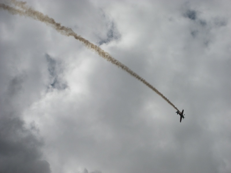 a plane flying high up in the sky on a cloudy day