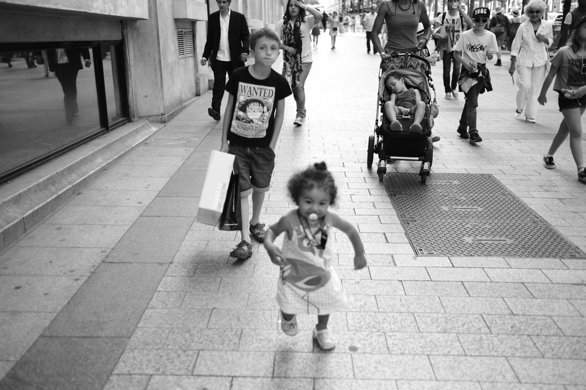 black and white image of children in shopping center