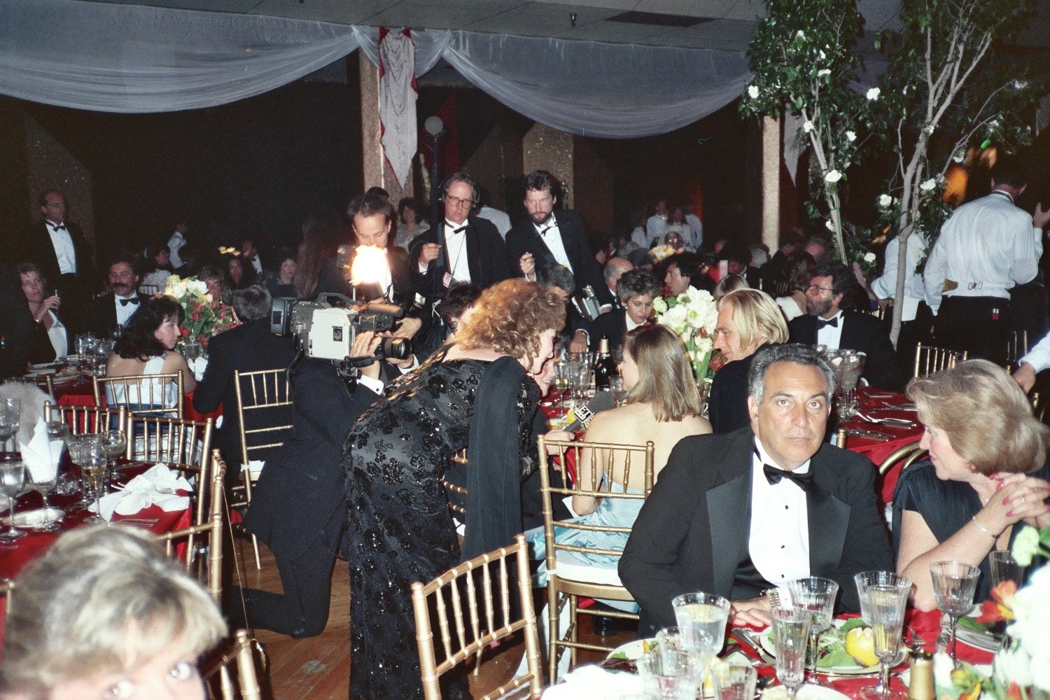 many people sitting around tables at formal functions