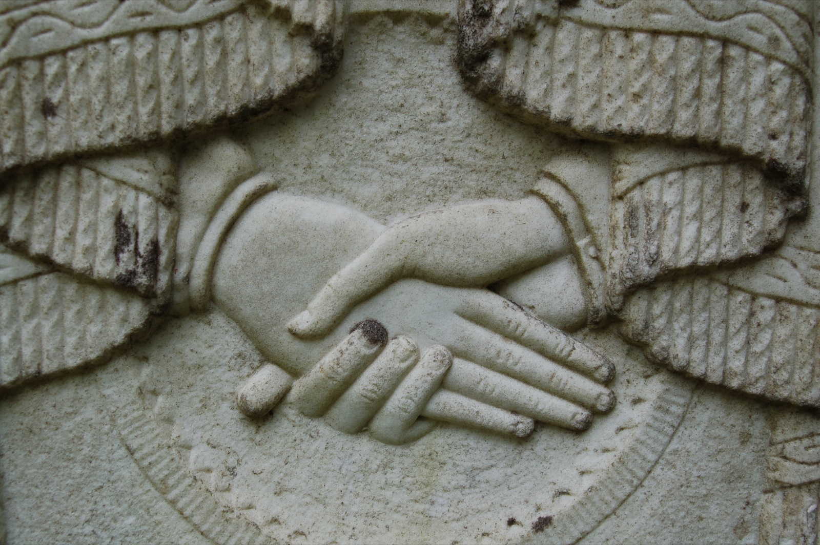 a close up of a hand on top of a statue