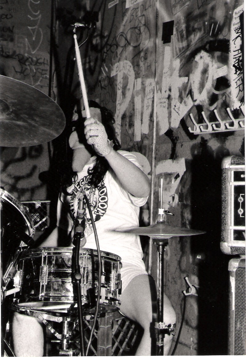 a black and white po of a woman playing drums