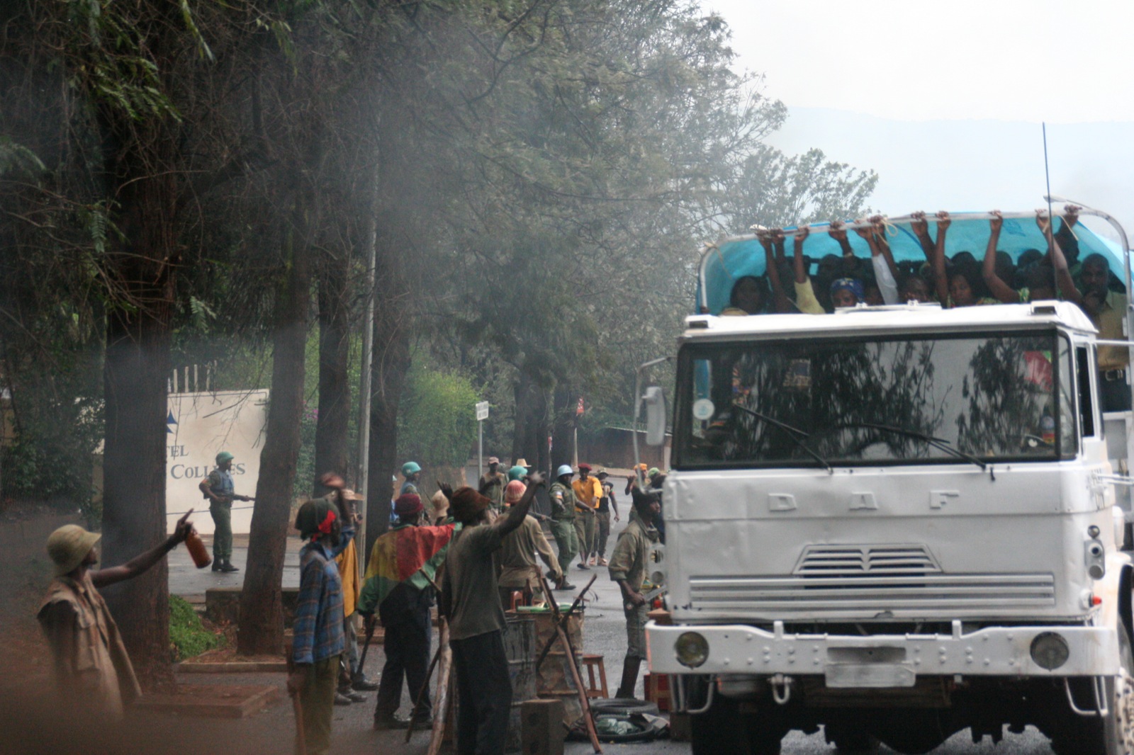 a crowd of people standing around a big truck