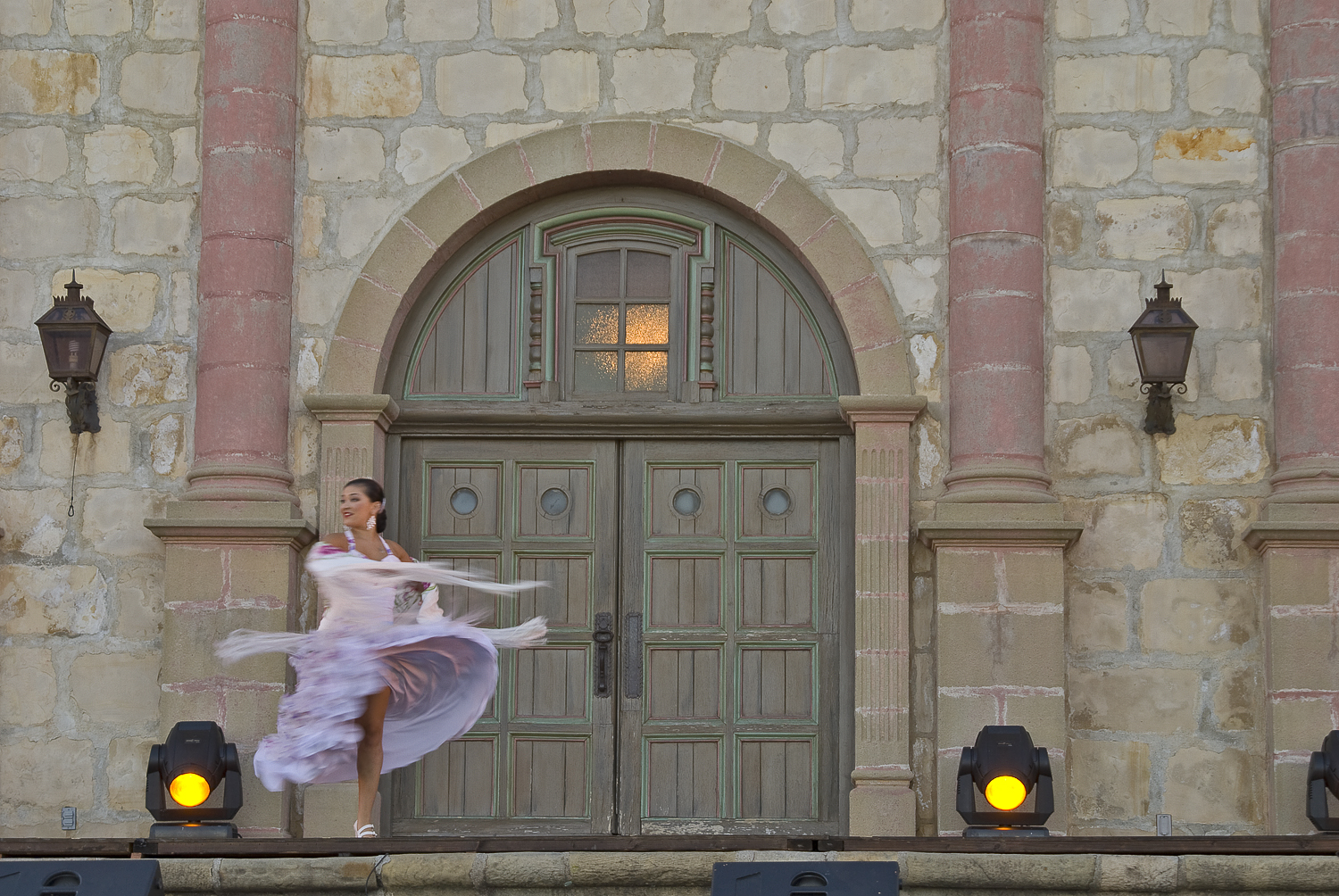 a woman in a dress standing outside a door