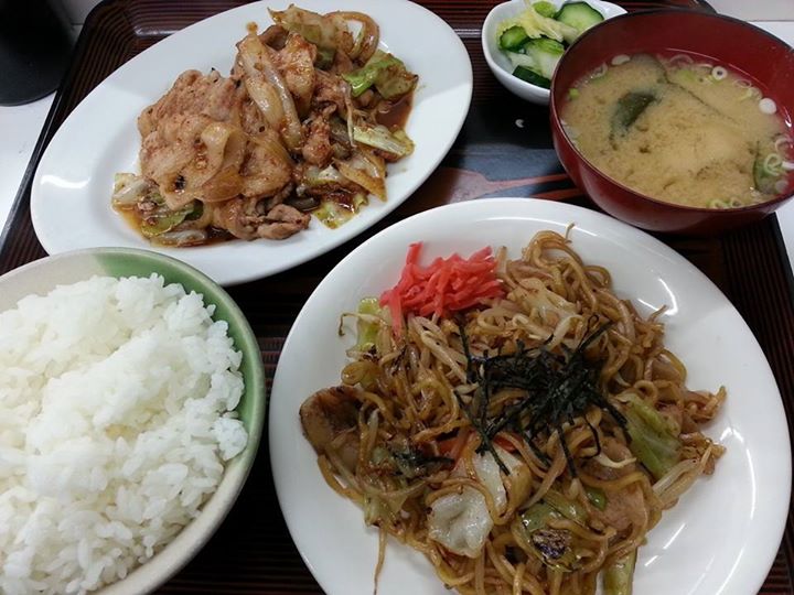 an assortment of chinese dishes of food are on a tray