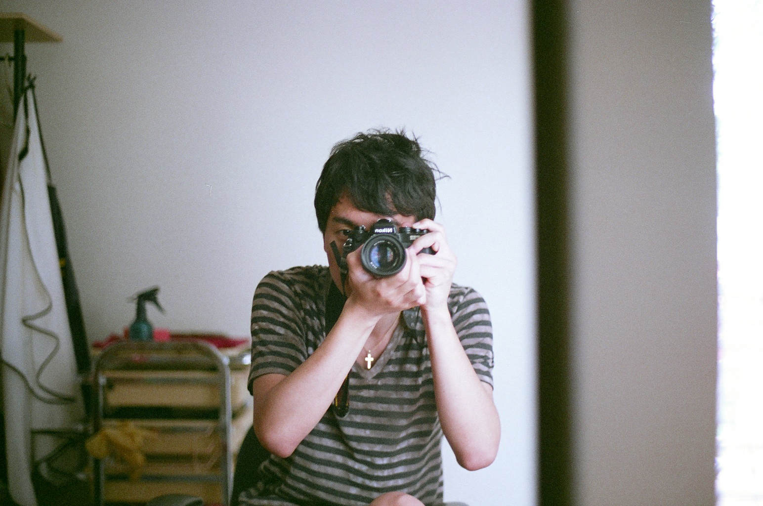 the reflection of a person in a mirror holding up a camera