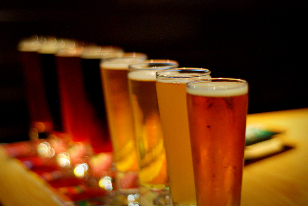 a row of four beers in front of others