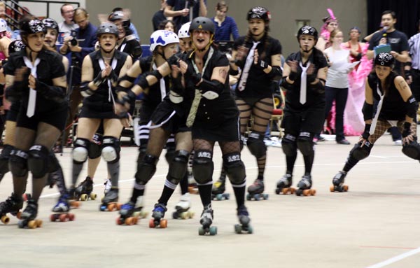 a large group of roller skaters dressed in black