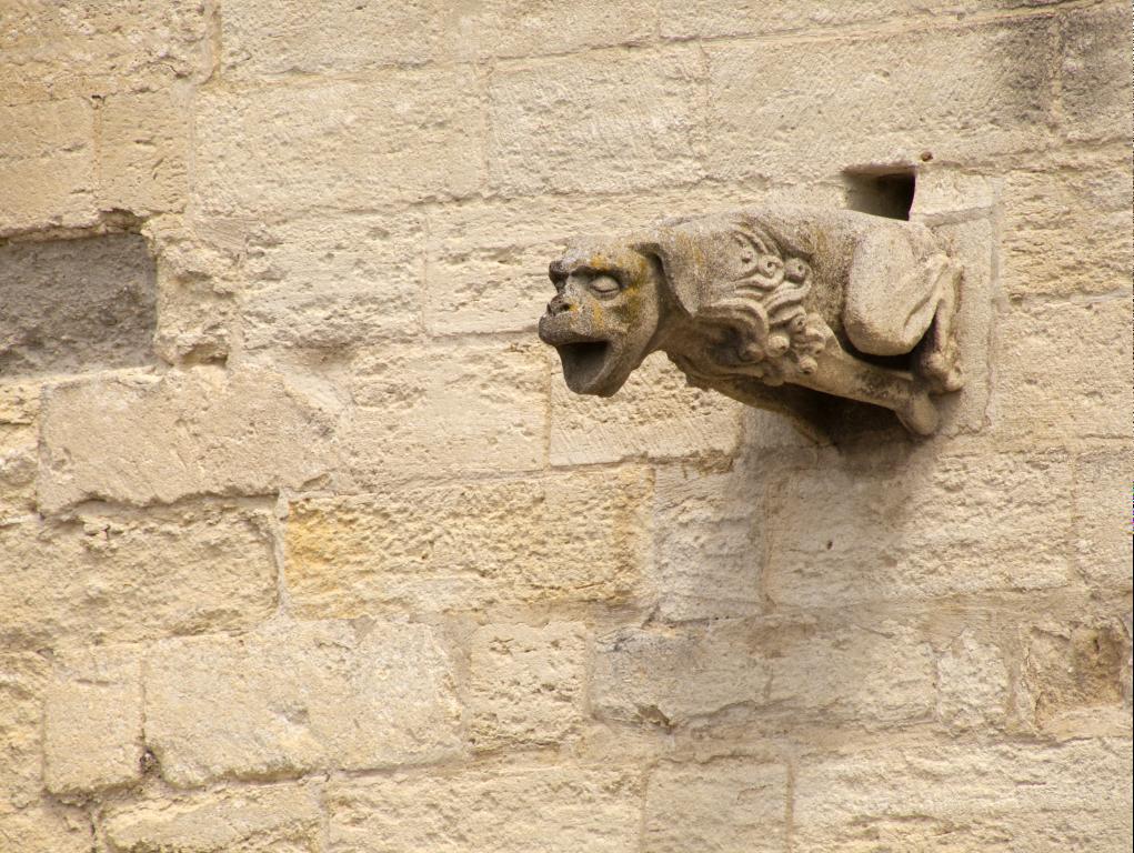 a statue on the side of a building with bricks