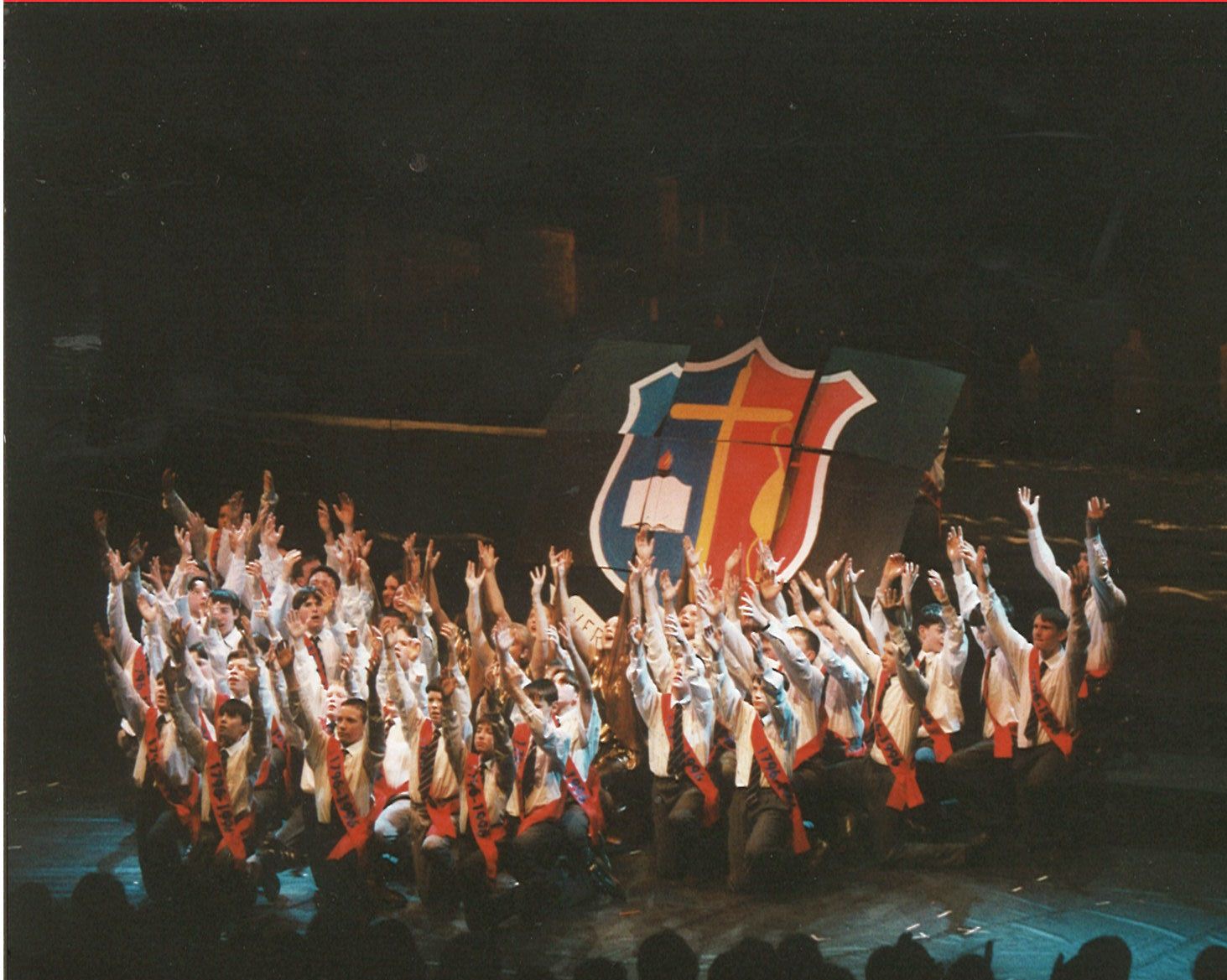 an elaborate group of performers holding an flag